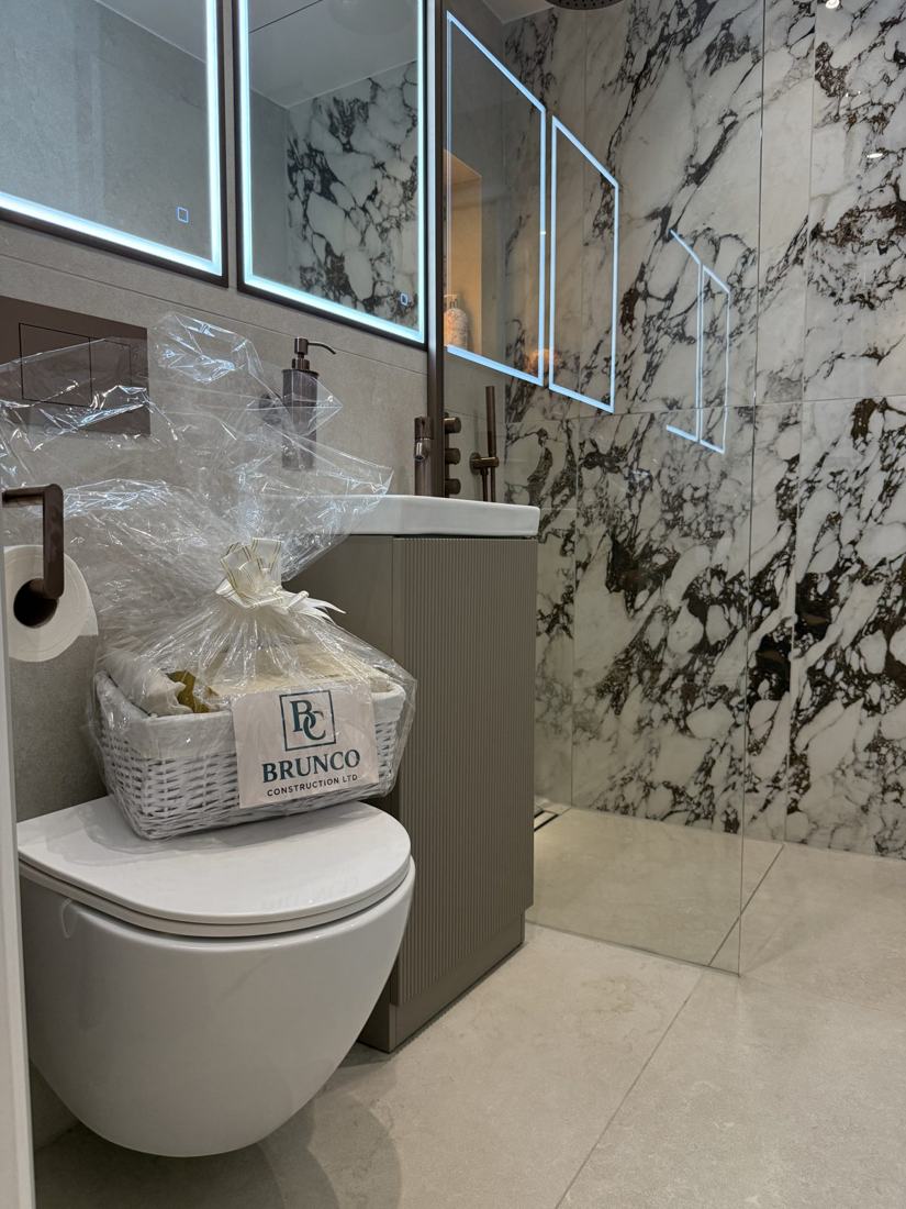 Walk-in shower with bookmatched marble wall