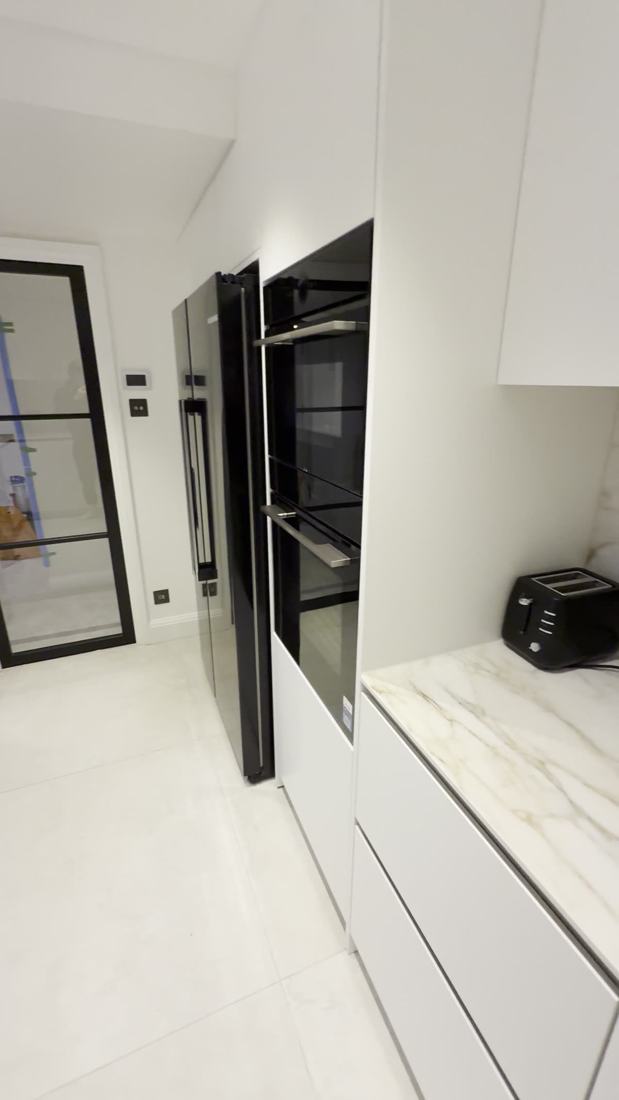 Calacatta kitchen with brass gas hob